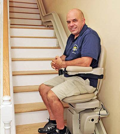 Stair lift repair and service-man sitting on a chair after Stairlift Service in Ocean City, NJ, Sea Isle City, Wildwood, Cape May, Villas, NJ, Cape May Court House