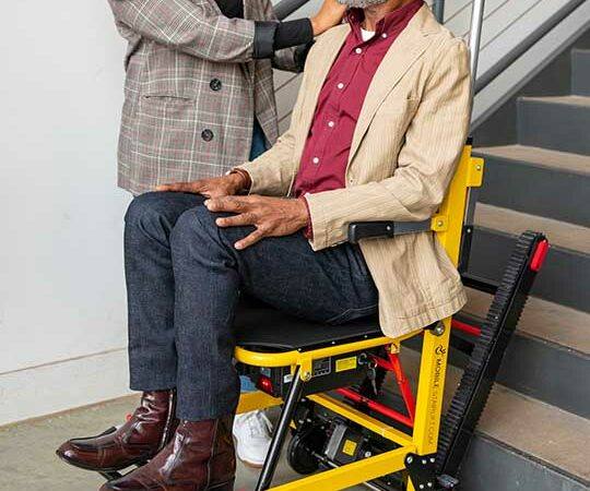 a man being helped upstairs using a Lift Chair, Stairlift, Home Access Ramps, and Medical Scooters in Cherry Hill, NJ