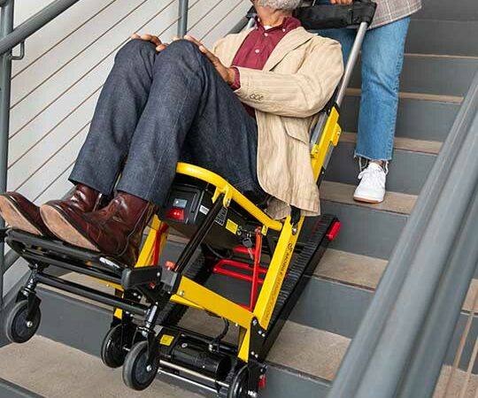 helping a man in a chair get upstairs using a Lift Chair, Stairlift Repair, Chairlift Service, and Mobility Scooters in Marlton, NJ